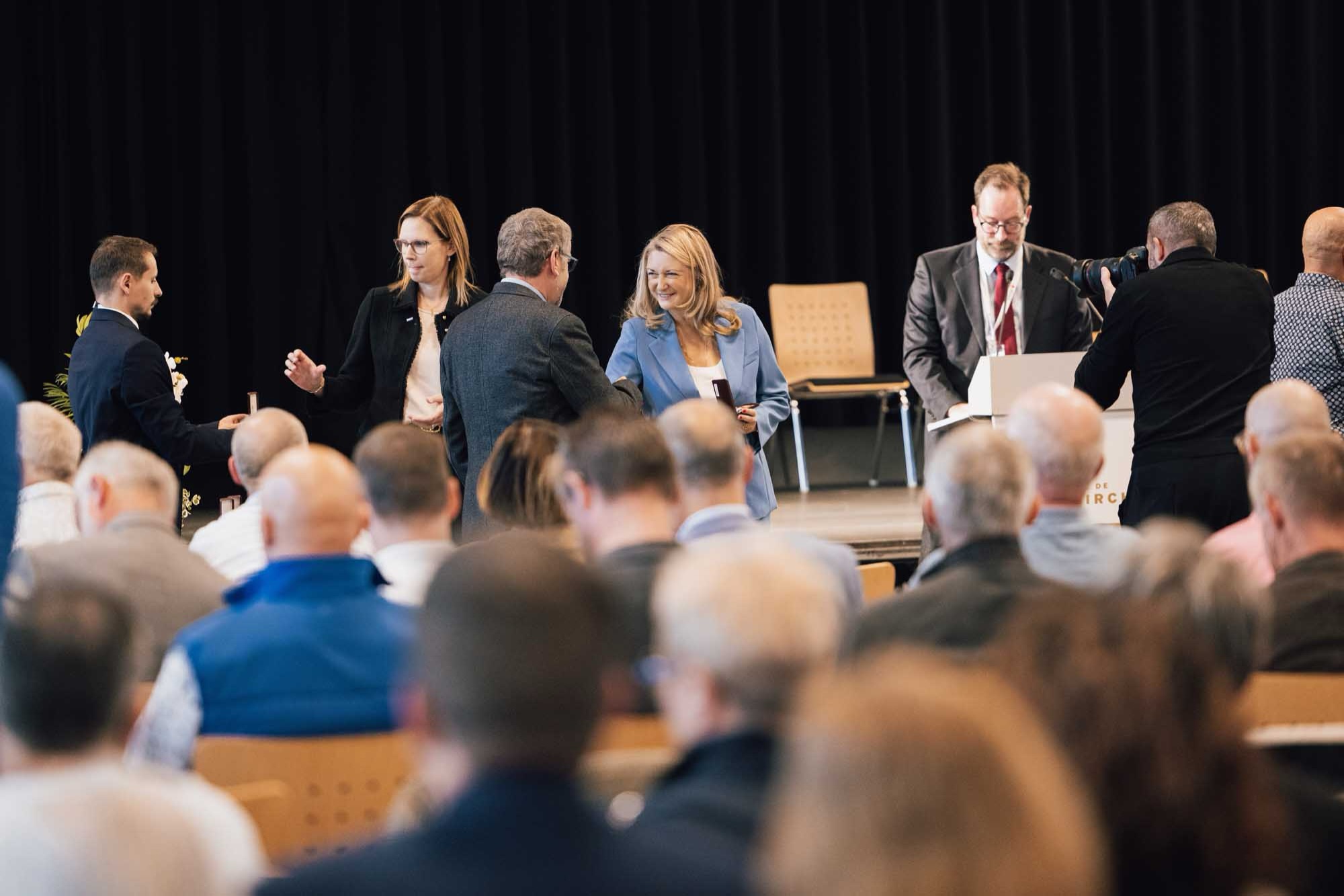 Grand Duchess Stephanie of Luxembourg, in a light blue blazer, holding a medal case at the blood donor medal ceremony in Diekirch on 10 October 2026